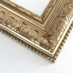 This 3-1/2 " Classic Sliver frame features an elegant leaf design, and a beaded outer lip. The raised design has a red brown patina with brushed gold-silver showing through on the peaks. The steep profile and inner border are a brushed gold-silver.