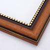 This solid wood, steeply curved frame features a natural, walnut finish that fades into deep brown approaching a gold foil-beaded inner lip.  The outer edge has a slender dashed border in gold foil.

2 " width: ideal for medium images.  Add some elegance to a family portrait, or border an old oil painting or print with this timeless frame.