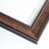 This smooth scooped frame is accentuated by a soft gradient of cherry browns. The frame features a darker lip on the inner and outer edge of the profile with an almost metallic like finish due to the traditional veneer. The natural wood grain faintly appears against the golden brown hues of the profile.