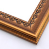 This solid wood frame features a crown moulding profile in a dark, brushed gold.  The slight distressing on the deeply scooped face and around the delicate inner design give it an antique look that suits old paintings and family portraits alike.

2.25 " width and 1 " high at outer edge: ideal for medium- to large-size images.