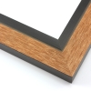 This unique frame with a raw wood face features long edge grain texture and a bright, pine-colour wash.  The frame forms a shallow V, with the matte black inner lip sloping out and then rising again (see illustration). The outer drop edge is also matte black.

2 " width: ideal for medium size artwork.  The modern style of this frame makes it a great match to more contemporary paintings and photography.