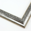 This classic, Victorian-style frame features a solid wood, reverse scoop profile.  The relief-detailed inner lip and sloped face are a textured silver foil, edged in a subtle bevel.

1.25 " width: ideal for small images. Border an acrylic or oil painting or print with this antiqued, high fashion frame.